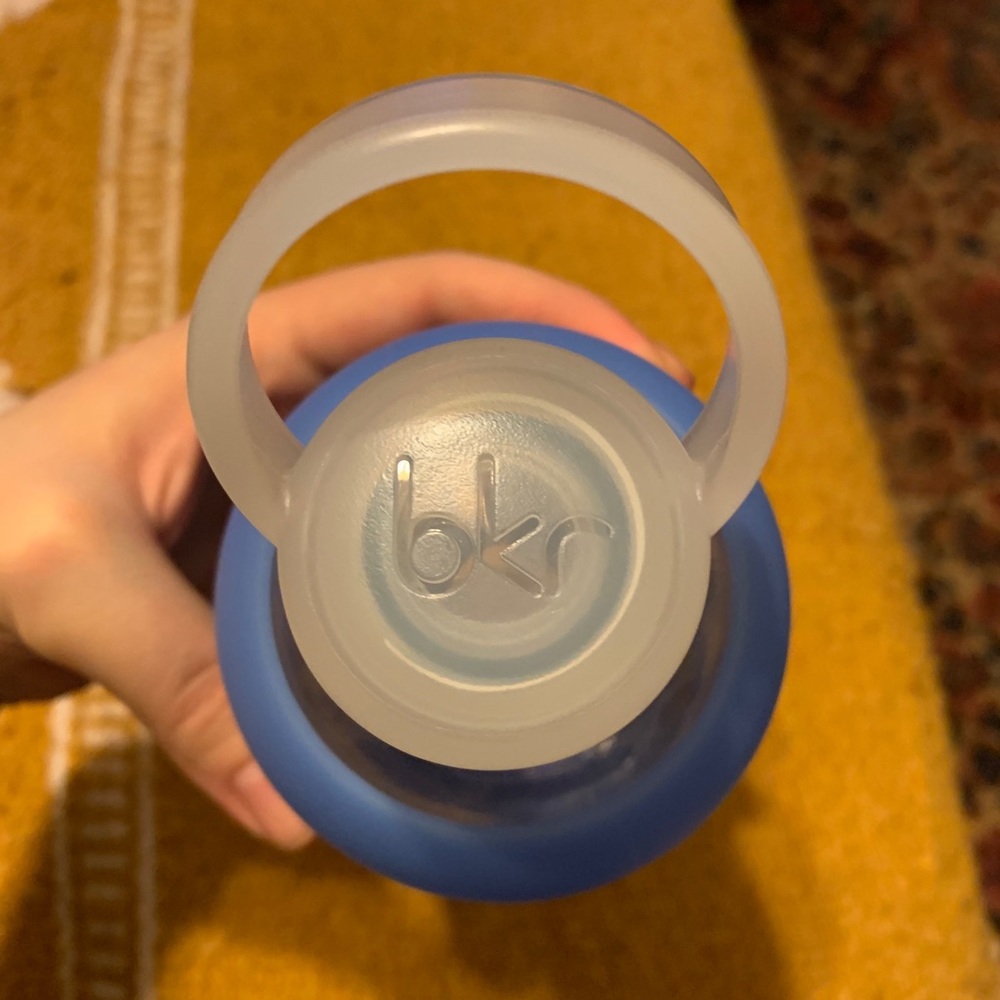 BKR glass water bottle with blue silicone cover.